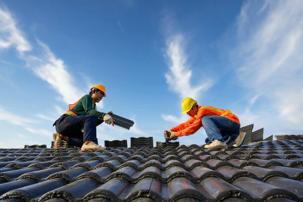 Roof repair contractor fixing broken tiles